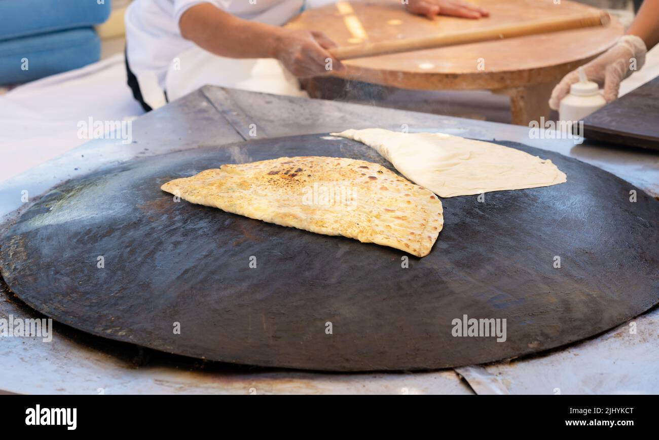 Cooking Traditional Turkish Gozleme Flatbread on the Stove Stock Photo