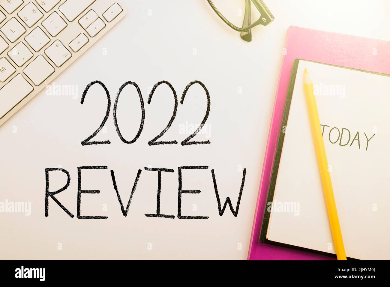 A vector of handwriting '2022 Review' sign near notebook with 'today ...