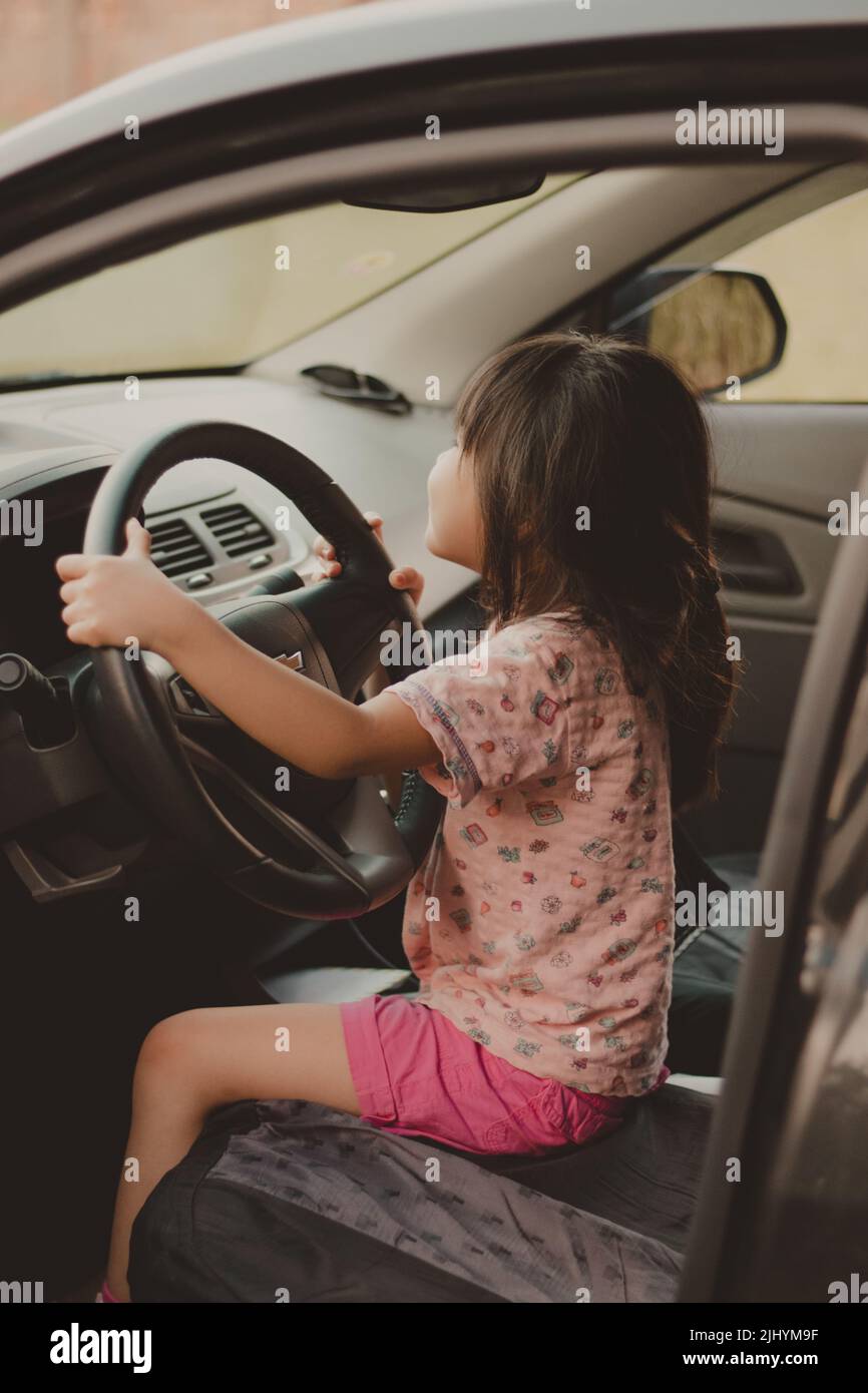 car travel fun concept. little boy driving car with adults people.  unconfident driver Stock Photo - Alamy