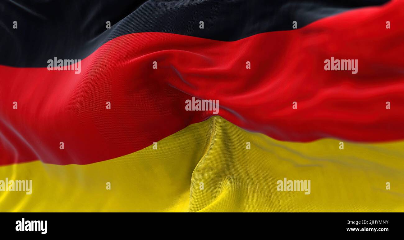 Close-up view of the German national flag waving in the wind. Germany is an European country. Stock Photo