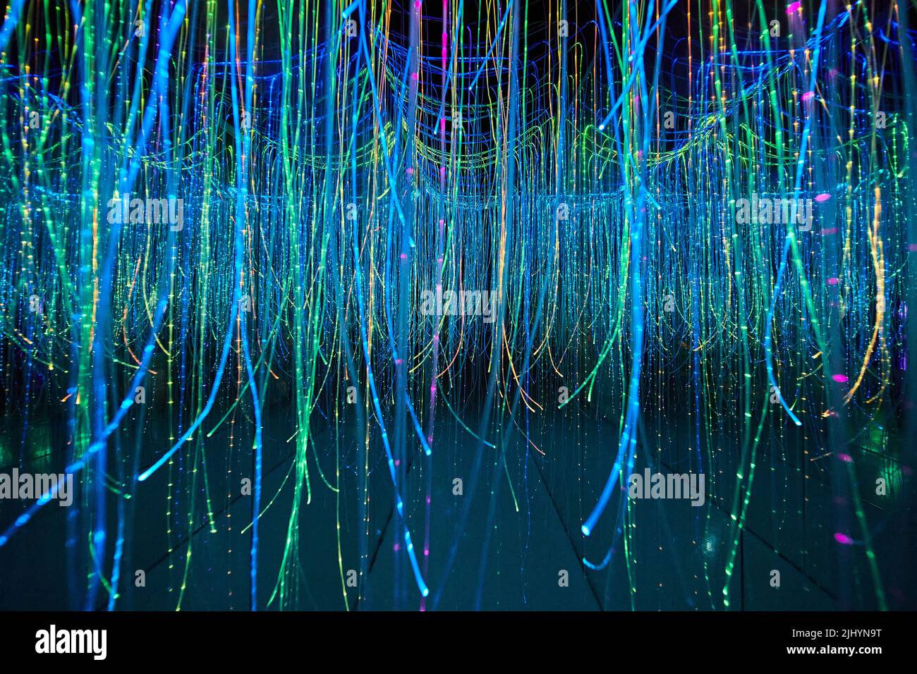 Mirror hallway filled with glowing strings Stock Photo