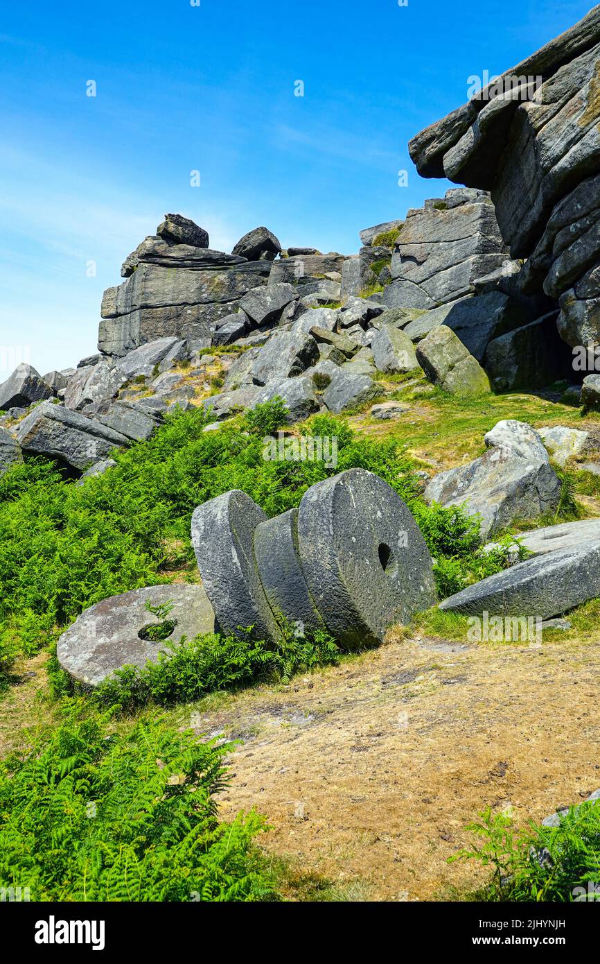 Abandoned millstones below Stanage Edge, gritstone cliff, Peak District National Park, Derbyshire, UK Stock Photo