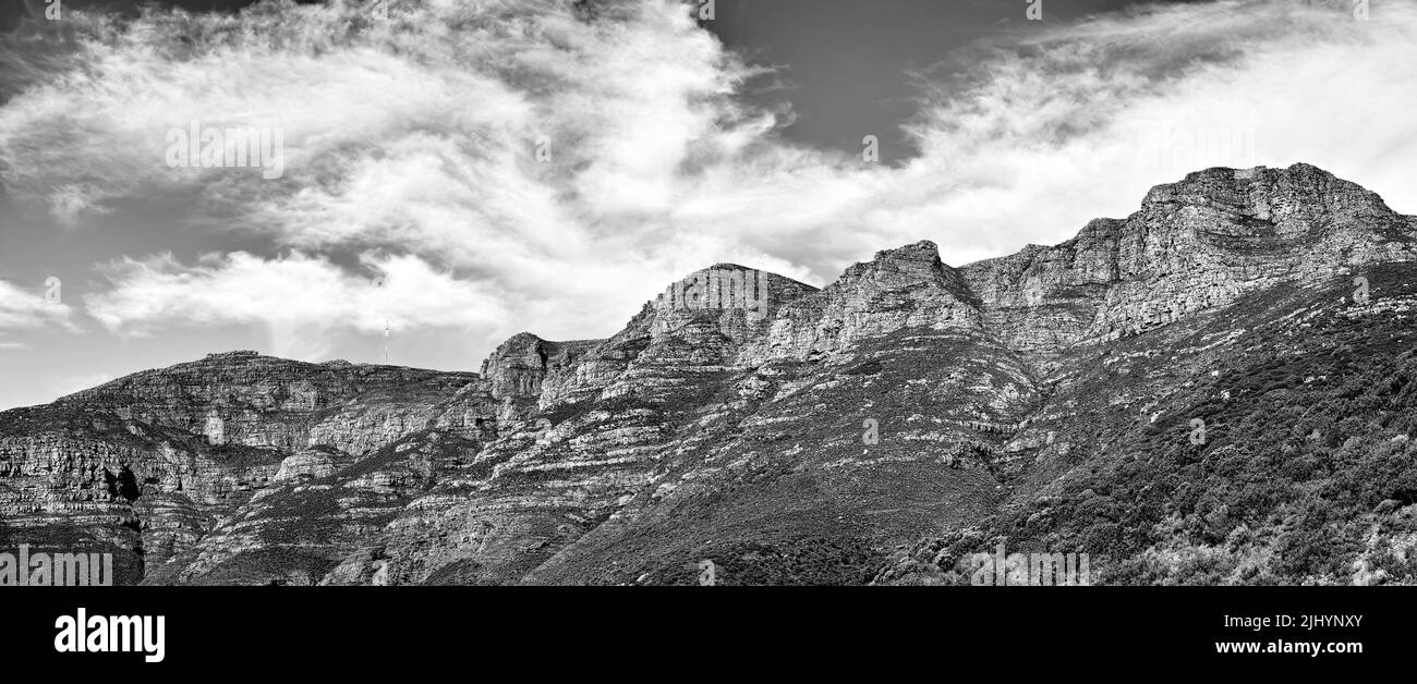 Black and white landscape of mountains on a cloudy sky background with copy space. Nature view of popular landmark, Twelve Apostles mountain, in Stock Photo