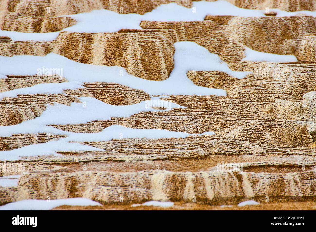 Yellowstone hot spring terraces in detail with patches of snow Stock Photo