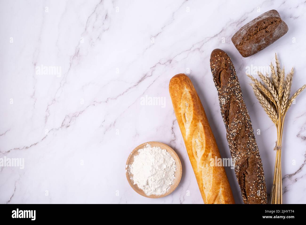 Bakery - various kinds of breadstuff. Bread rolls, baguette, croissant and flour Stock Photo