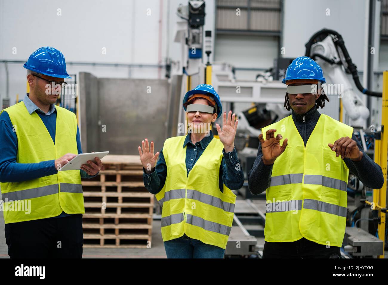 Group of robotics workers using virtual reality in their work Stock Photo