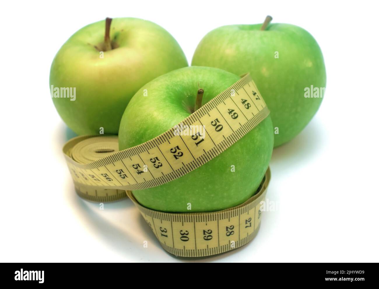Green apple wrapped by measuring tape isolated on white background Stock Photo