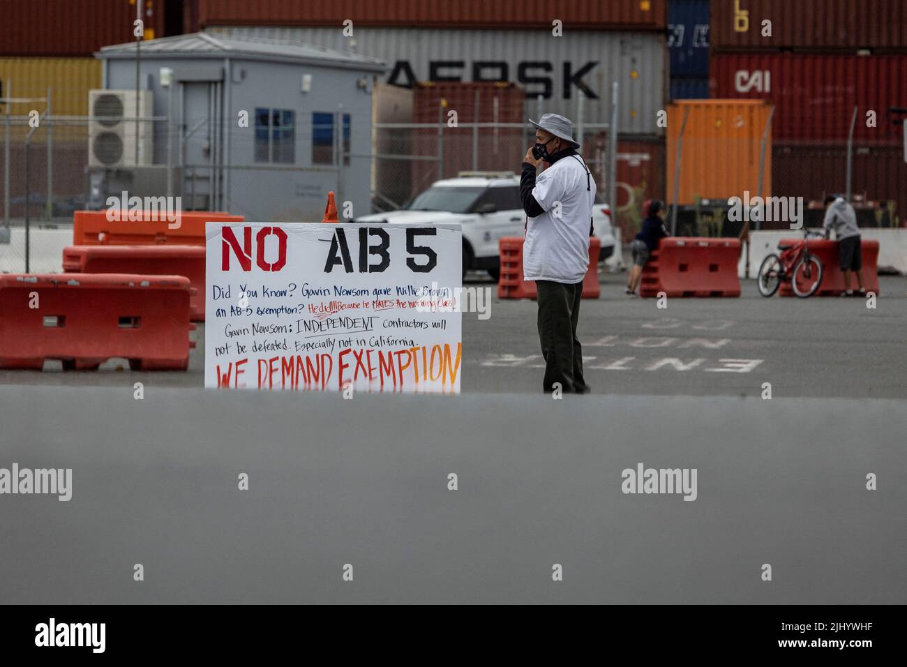 A truck driver joins a gathering to block the entrance of trucks at a container terminal at the Port of Oakland, during a protest against California's law known as AB5, in Oakland, California, July 21, 2022. REUTERS/Carlos Barria Stock Photo