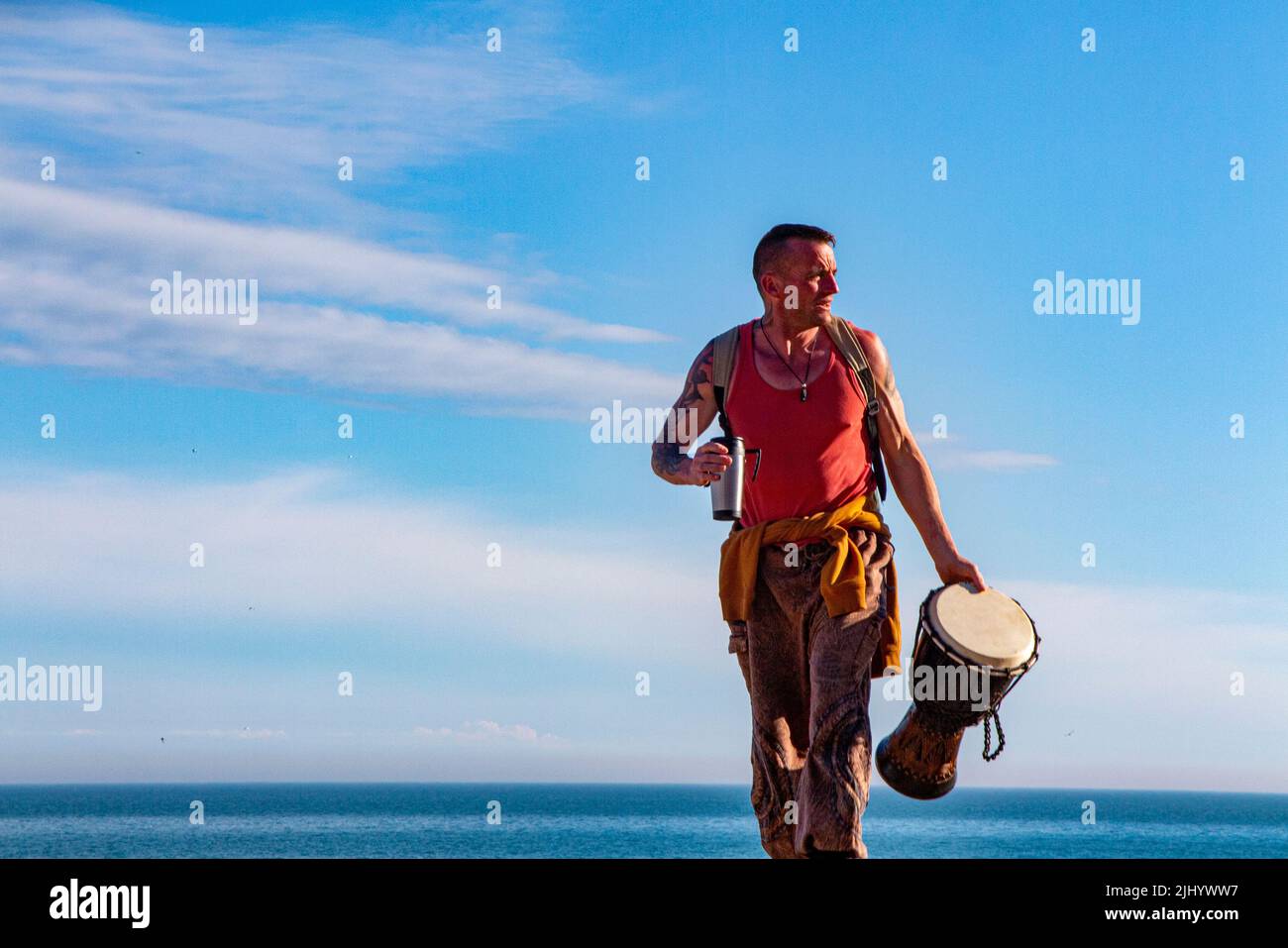 A cool St Leonard's resident plays his bongos on the beach at Goat