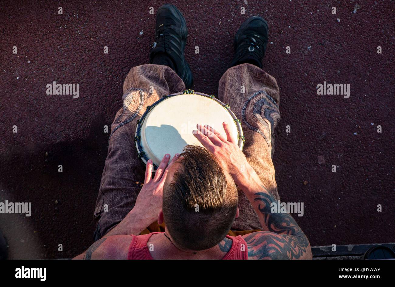 A cool St Leonard's resident plays his bongos on the beach at Goat