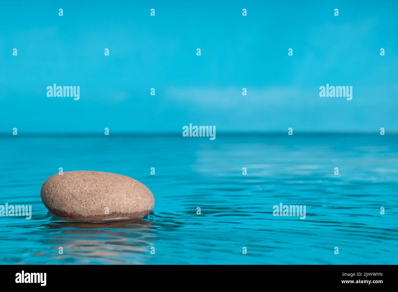 Zenstyle minimalist composition. Stone in water with space for text