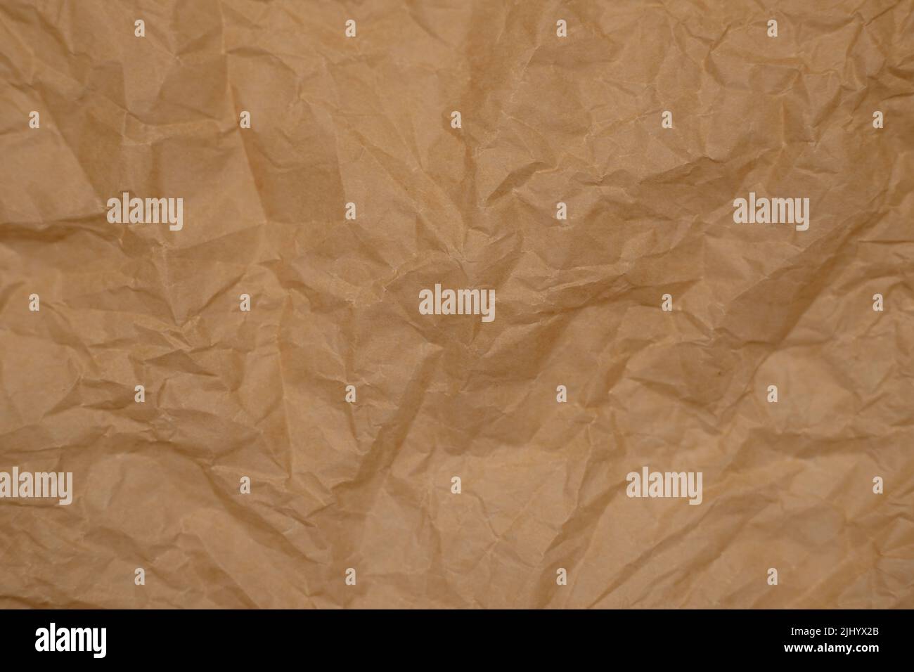 crumpled parchment paper. background from old paper. baking paper Stock