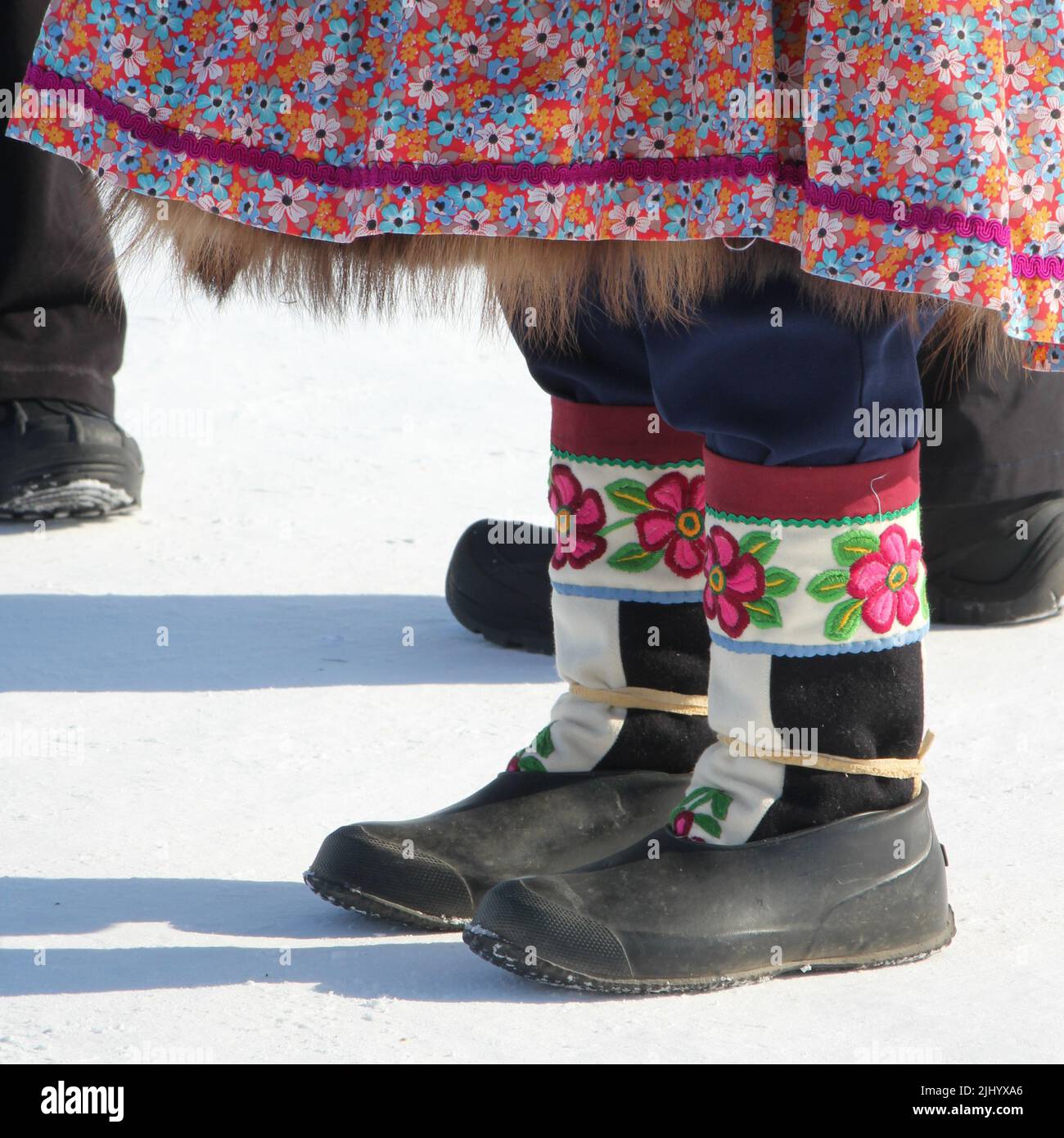 Women's traditional Indigenous embroidered moccasins and bottom of parka in winter at Muskrat Jamboree in Inuvik, Northwest Territories, Canada. Stock Photo