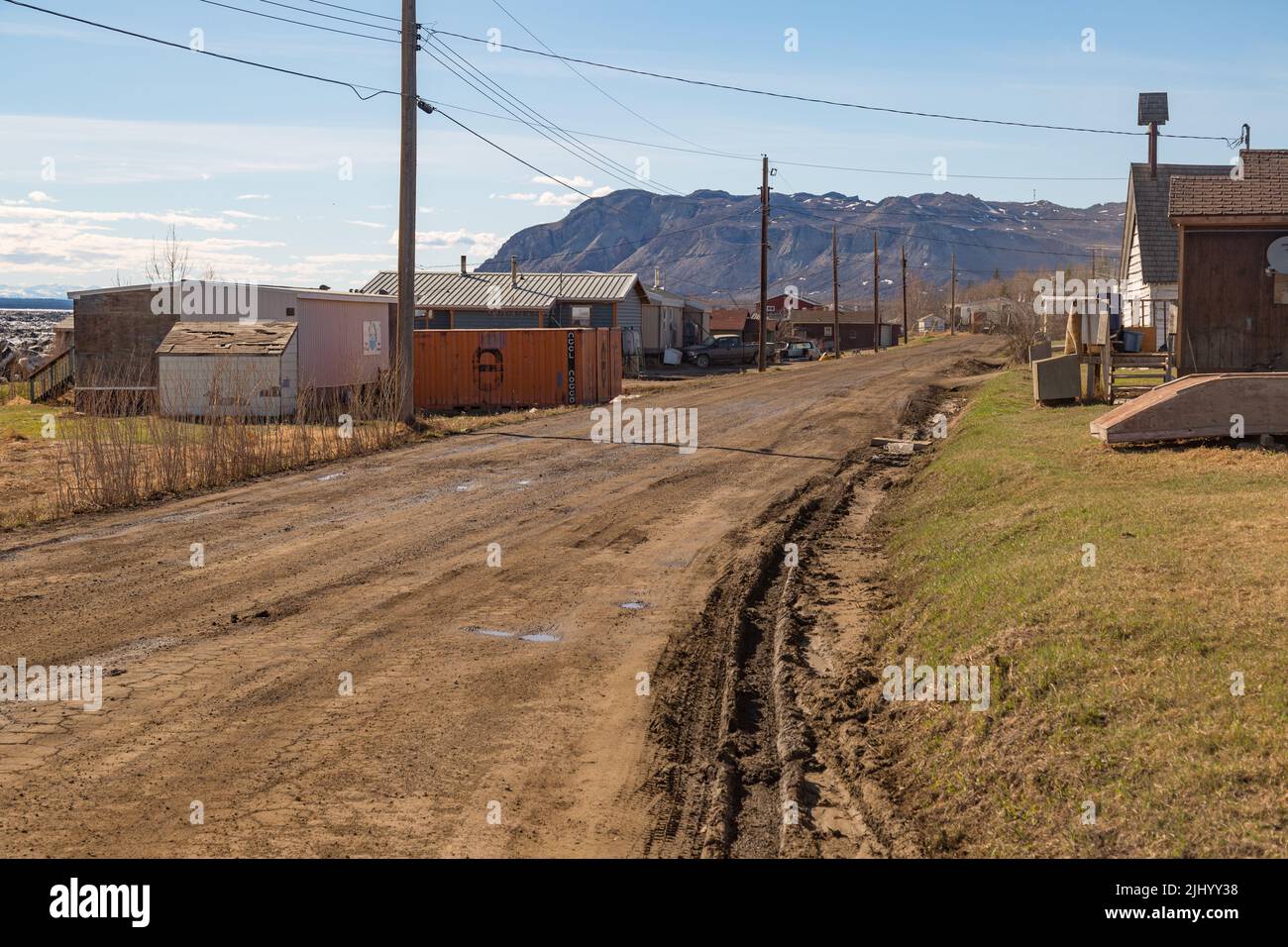 Houses along dirt road of the northern Indigenous community Tulita in spring, Northwest Territories, Canada. Stock Photo