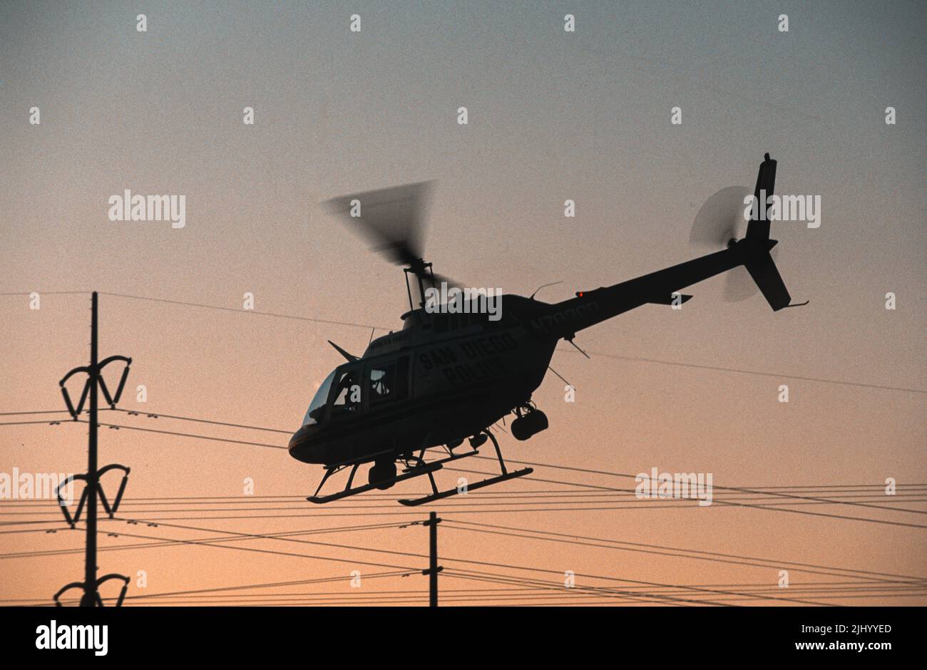 San diego police department able helicopter in silhouette at sunset