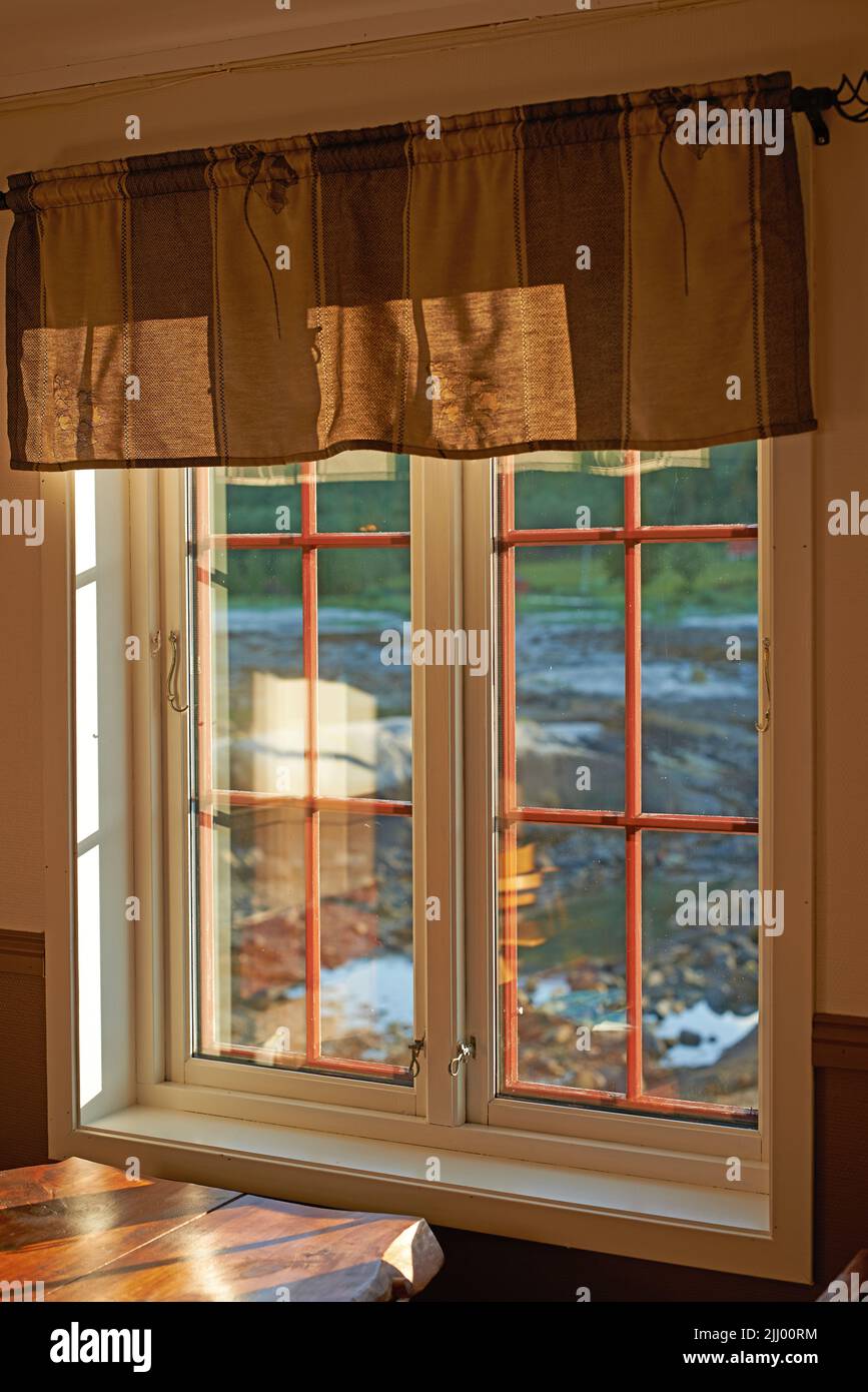 Old vintage window design wall in a home building. Background of outdoor terrain with light shining into windows. Wooden frame design with protective Stock Photo