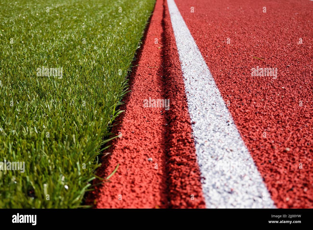 Sports stadium background. Red artificial rubber ground running tracks