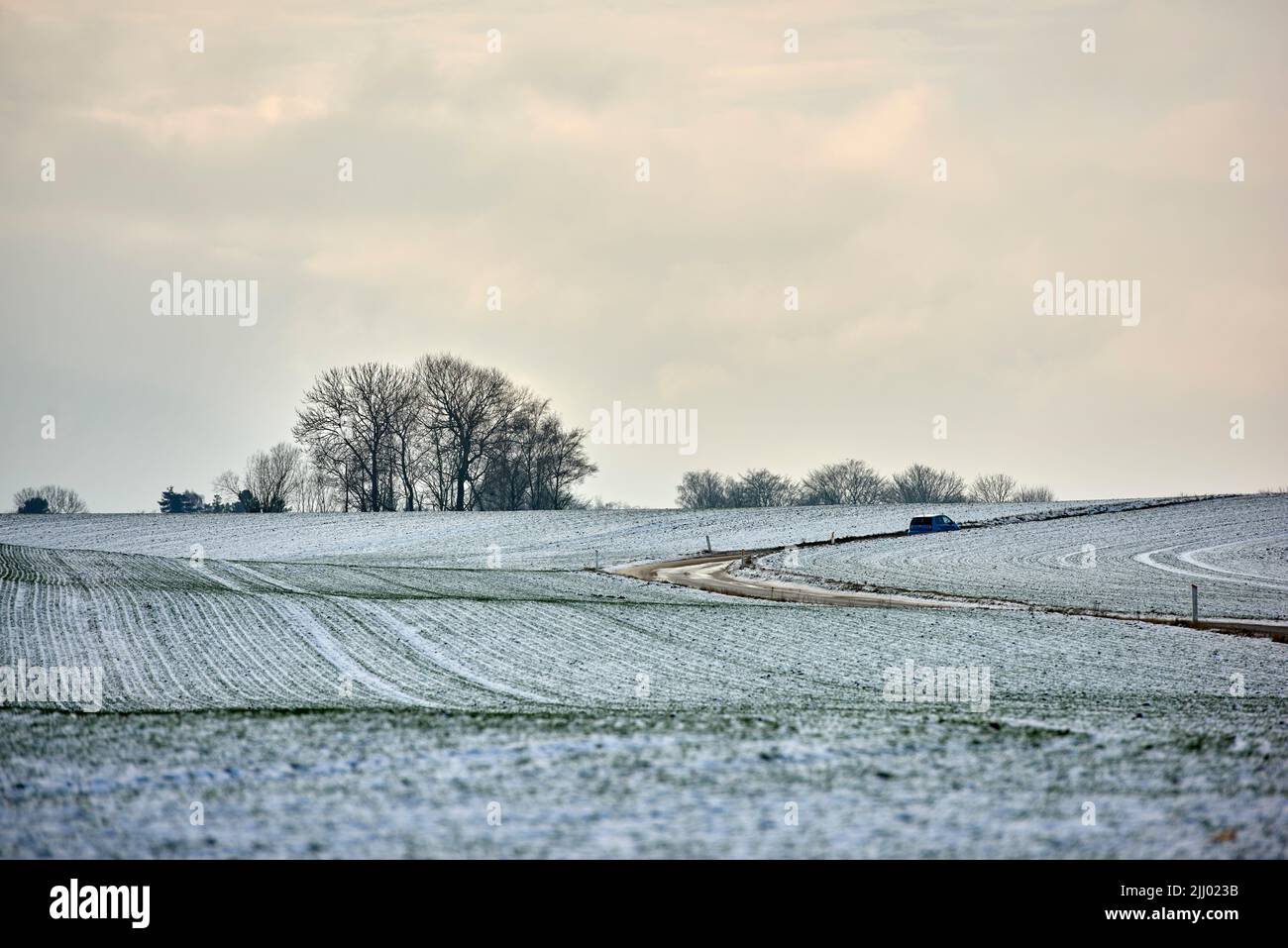 Landscape view of an empty and secluded field covered in snow during