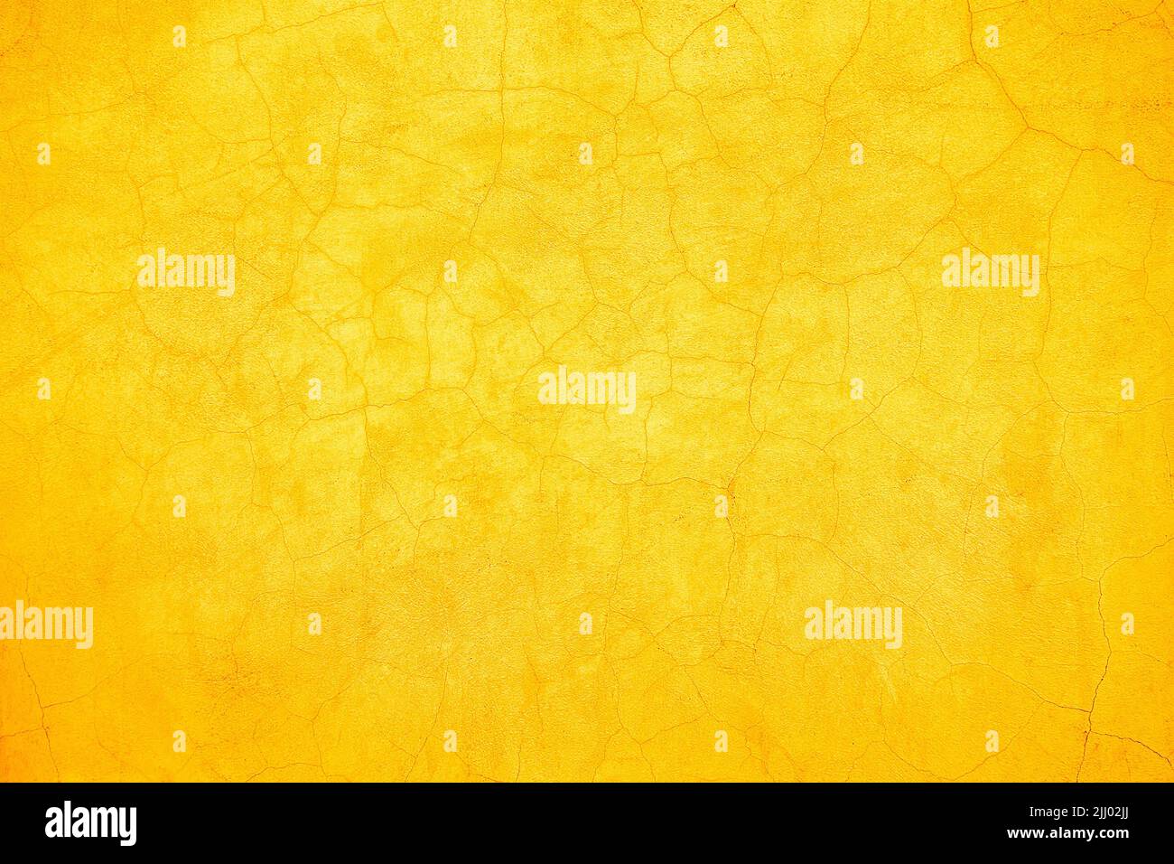 Abstract rustic yellow and orange cracked wall background texture design. Stock Photo