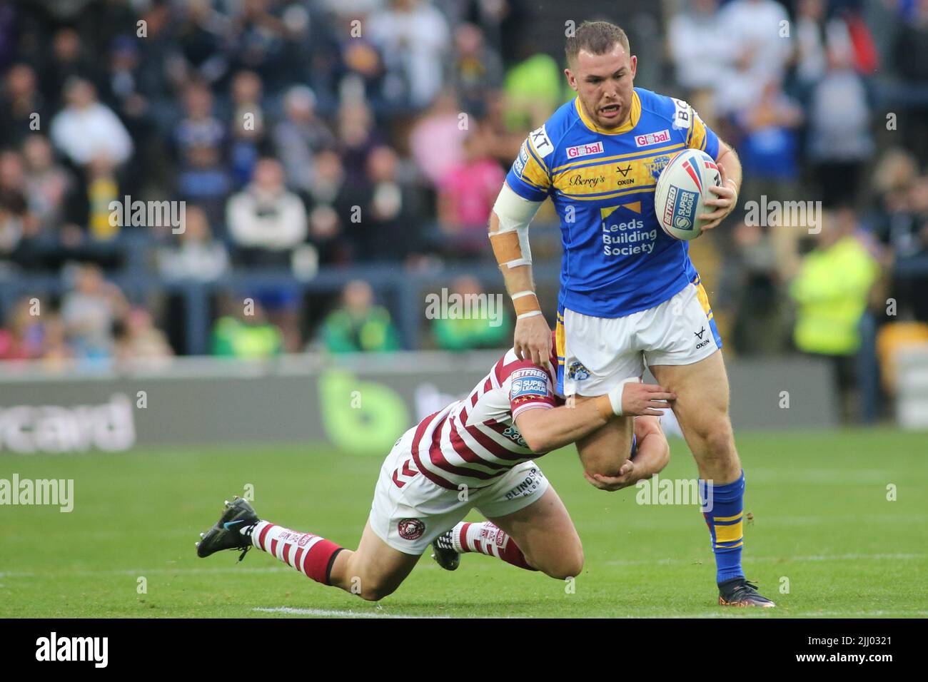 Leeds, UK. 21st July, 2022. Headingley Stadium, Leeds, West Yorkshire, 21st July 2022. Betfred Super League Leeds Rhinos v Wigan Warriors Cameron Smith of Leeds Rhinos tackled by Harry Smith of Wigan Warriors. Credit: Touchlinepics/Alamy Live News Stock Photo