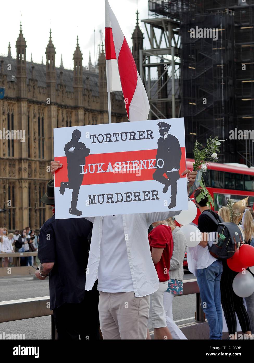 London, UK - August 23, 2020: Belarussian protester holding anti Lukashenko poster on Westminster Bridge in London, UK Stock Photo