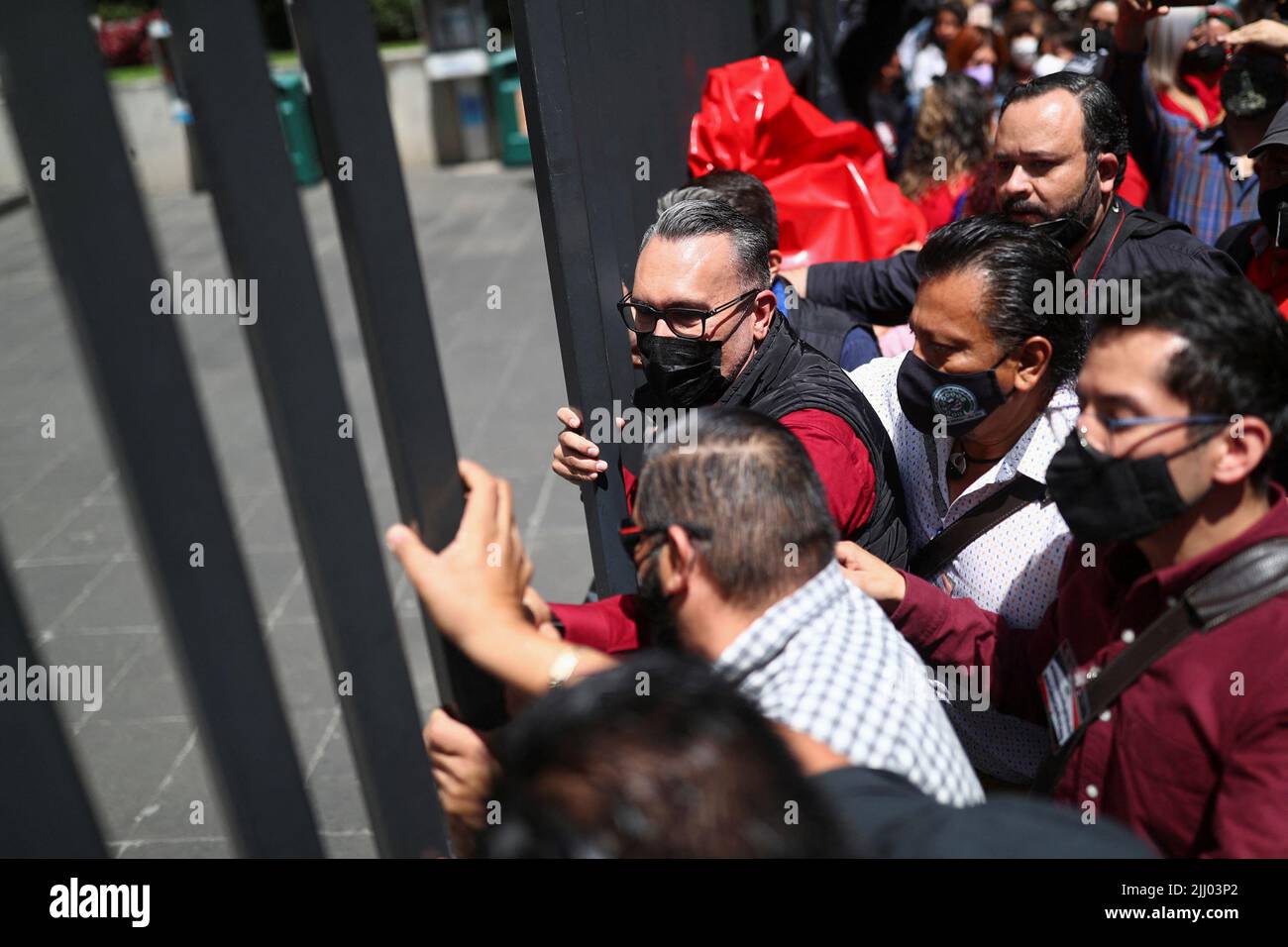 Employees close a fence as they protest outside the headquarters of Telmex after the company's union went on strike after failing to come to an agreement with the company over a new collective labour agreement, in Mexico City, Mexico, July 21, 2022. REUTERS/Edgard Garrido Stock Photo