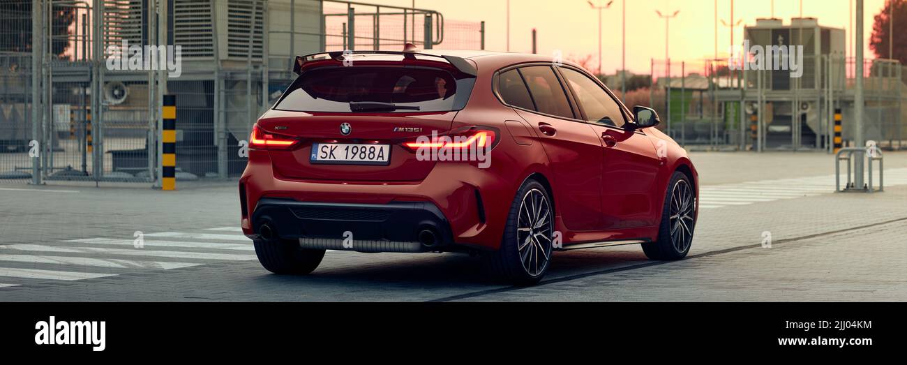 Red BMW M135i in a shopping mall parking lot. Model F40, produced from 2019. 306 hp engine, acceleration 0-100 km-h: 4.8 s. Katowice, Poland - Septemb Stock Photo