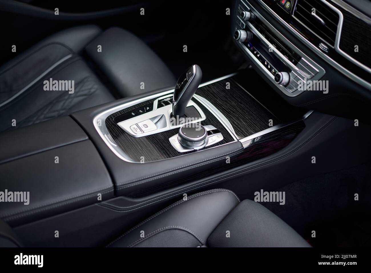 Automatic gear shift knob in a modern sports limousine car. Black car interior. Stock Photo