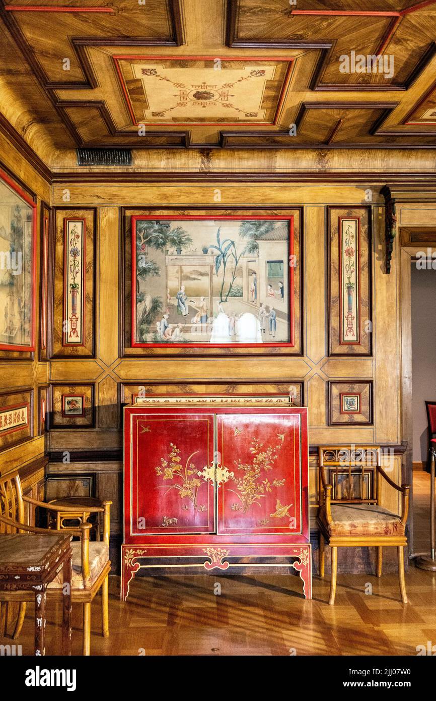 Red antique cabinet and oriental artwork inside the Chinese Room at 17th century baroque royal Wilanow Palace, Warsaw, Poland Stock Photo