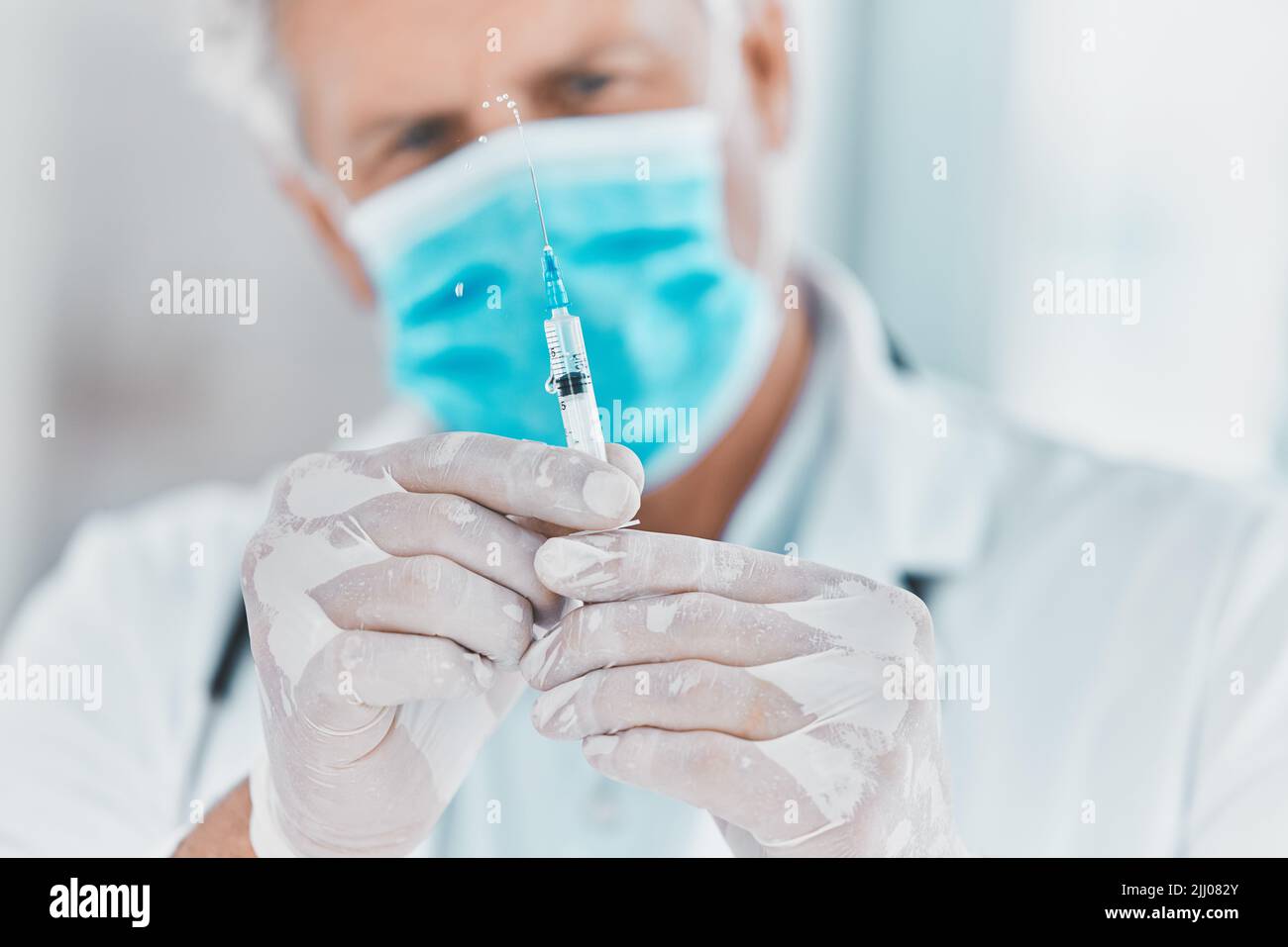 bringing health to the masses. a doctor preparing to administer an ...
