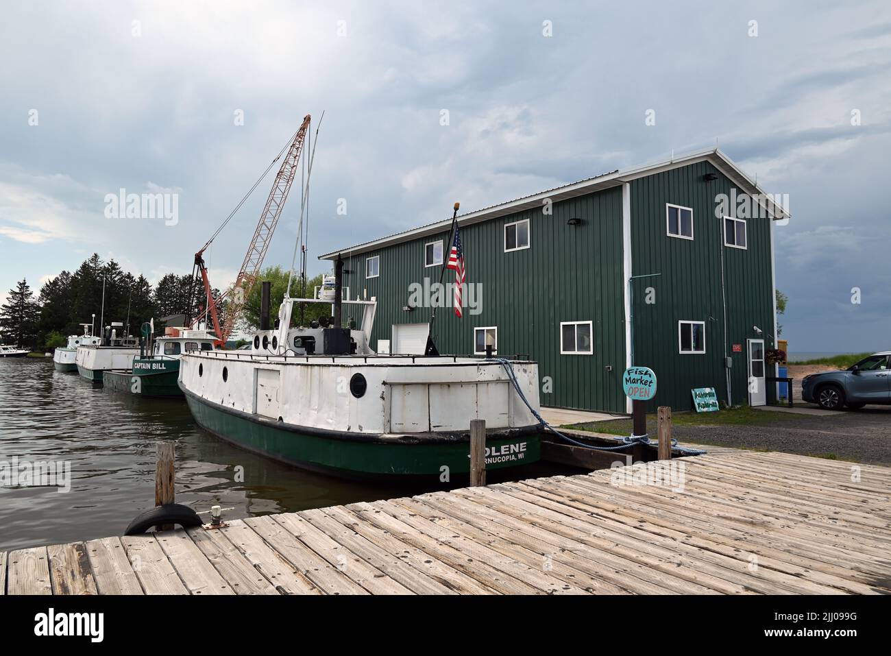 Commercial fishing boats are tied off at the dock at Halvarsan ...