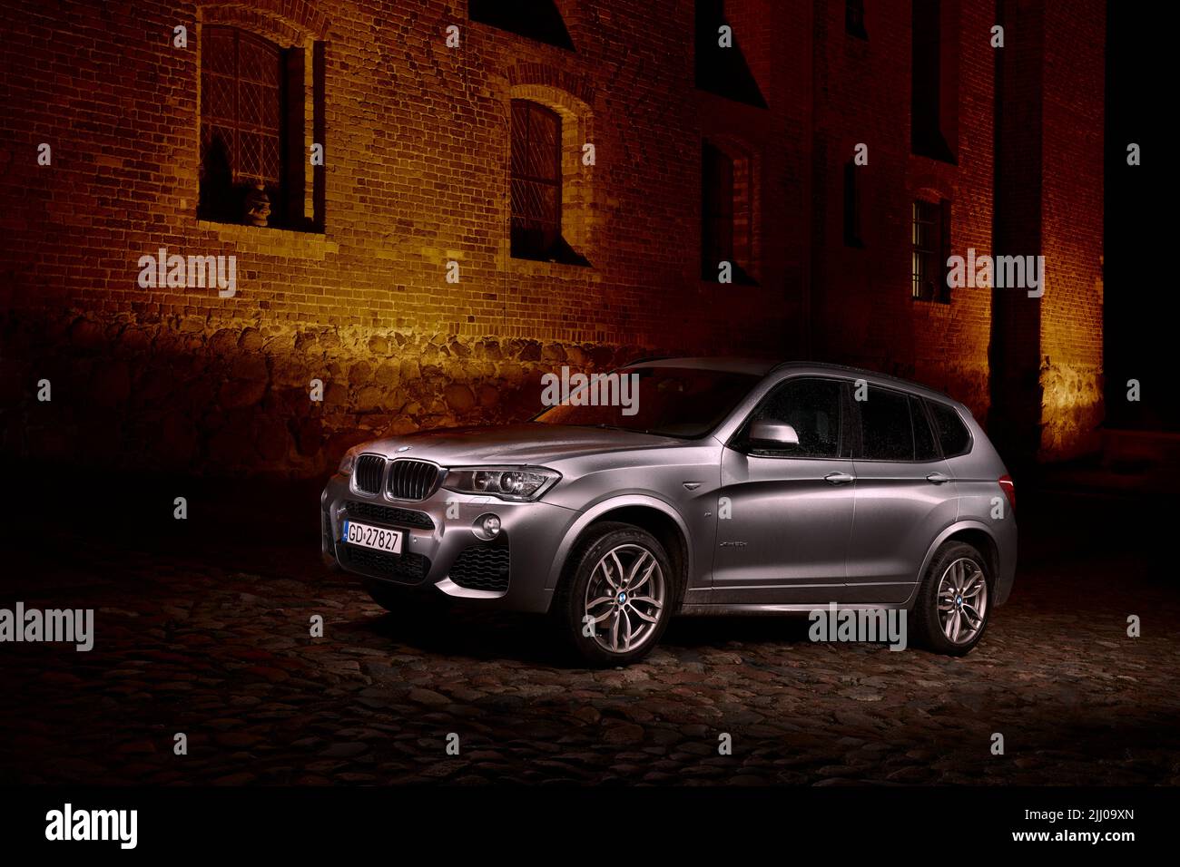 Silver BMW X3, parked in front of Gniew Castle at night. Gniew, Poland, 27.07.2017 Stock Photo