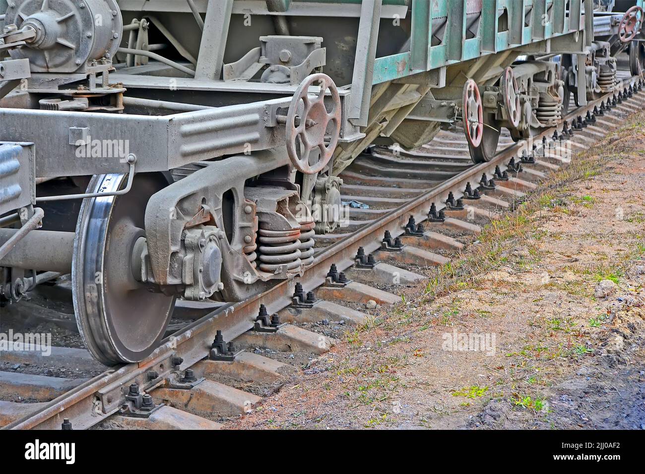 vintage cargo wagon train line with valve tap heap in nasty day, transportation technology diversity Stock Photo