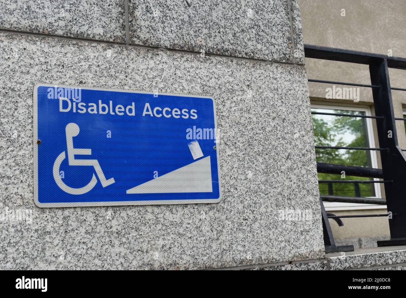 Sign showing the route into the buiding for wheelchair users: 'Disabled Access'. Stock Photo