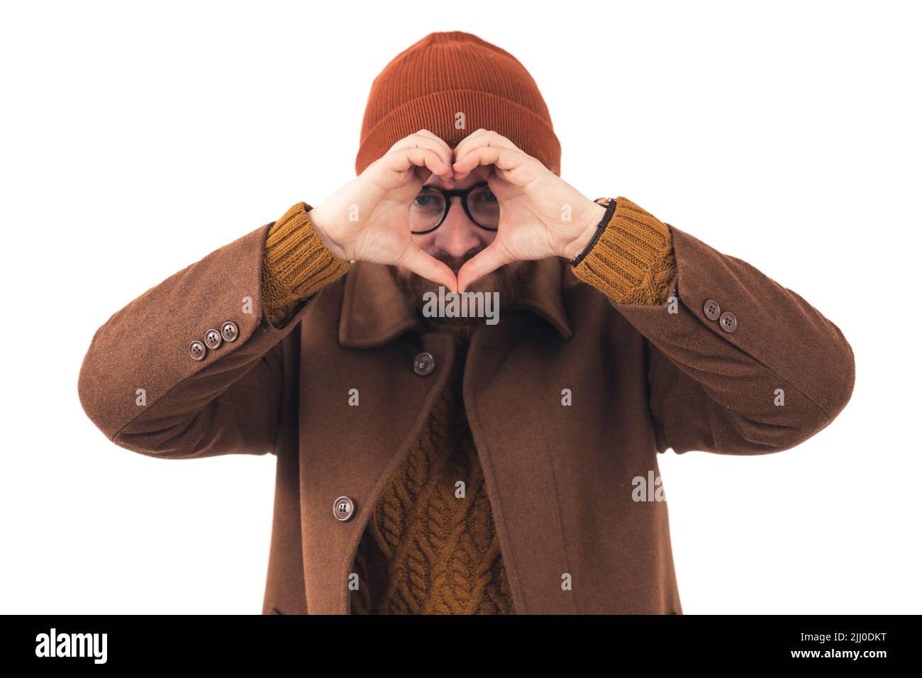 Man in his 30s making heart shape gesture from his fingers - isolated on white background medium shot. High quality photo Stock Photo