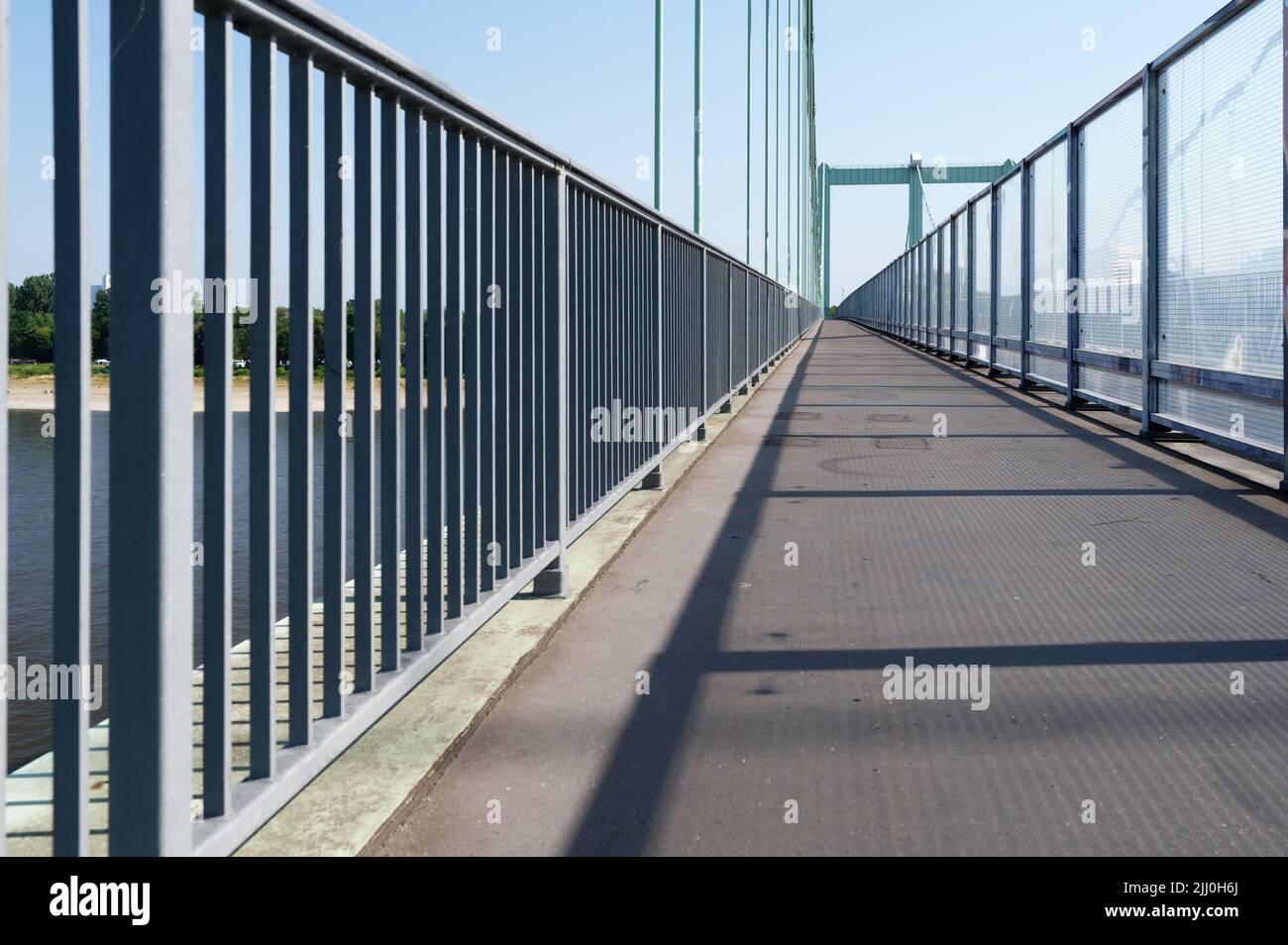 footpath of a highway bridge over the rhine separated from the roadway by glass noise barriers Stock Photo
