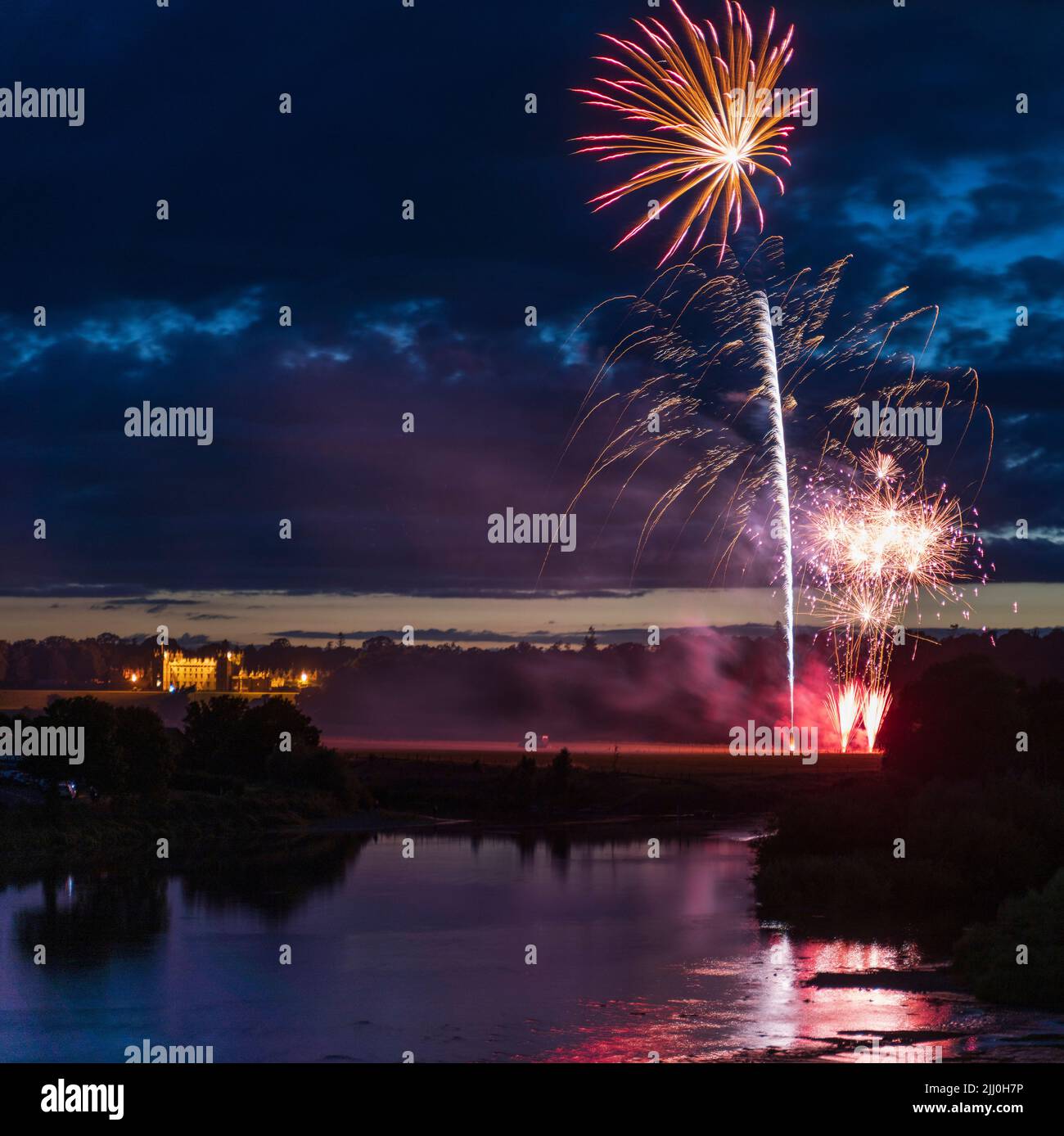 Annual Kelso, Scotland, common riding civic week summer festival - fireworks at 11.30pm July 20th. Seen from Kelso old bridge with Floors Castle flood Stock Photo