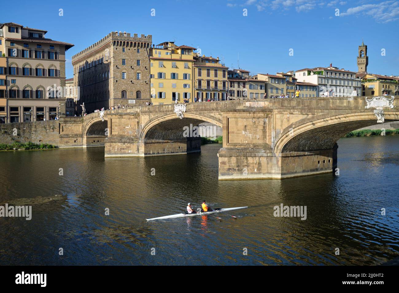Kayaking past the Ponte Santa Trinita Bridge and the River Arno in Florence Italy Stock Photo