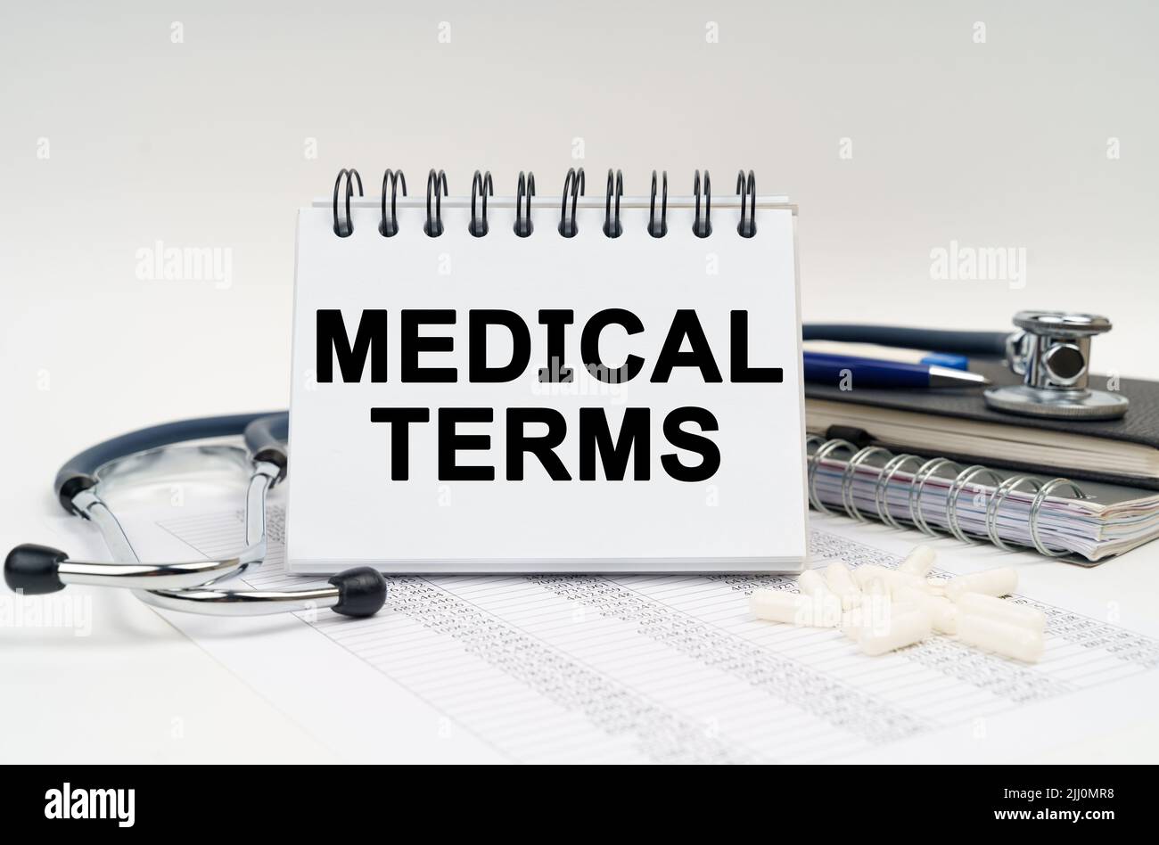 Medicine and health concept. On the table is a stethoscope, a diary and a  notebook with the inscription - MEDICAL TERMS Stock Photo - Alamy