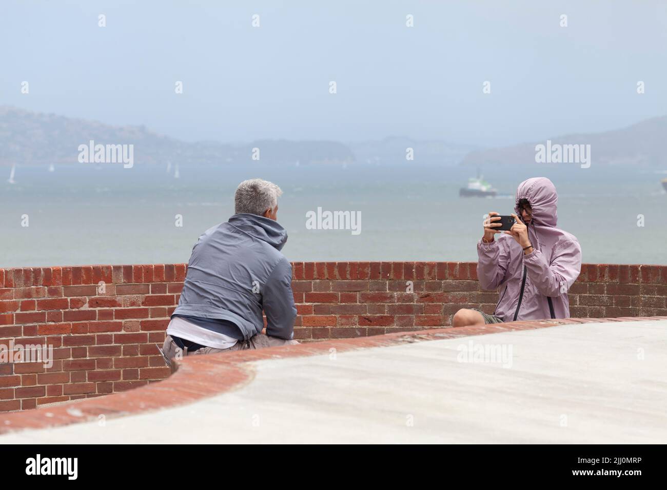 Tourists taking pictures on the roof of Fort Point, San Francisco, California, USA Stock Photo