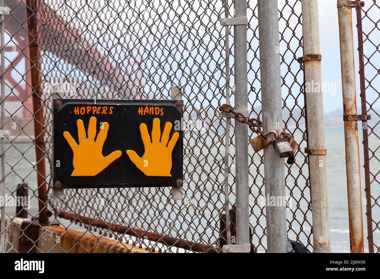 Hoppers Hands sign created by Ironworker and and volunteer suicide rescue worker Ken Hopper in 2000 hung by the chainlink fence at Fort Point Stock Photo