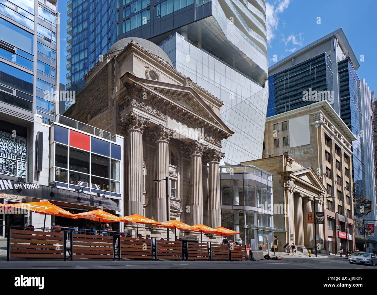 Toronto, Ontario, Canada - Outdoor seating at a pub on Yonge Street in downtown Toronto, with 19th century classical style bank facades preserved in m Stock Photo