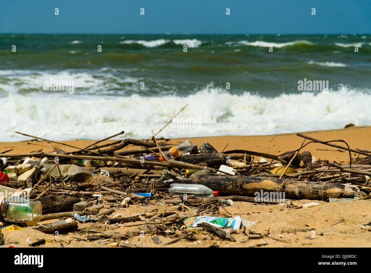 Plastic and wood waste on the beach pollute the environment. Negombo