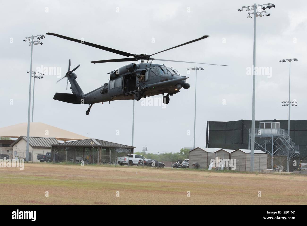 An HH-60 Pave Hawk commanded by Maj. Howard Palmer, aircraft commander, flew in from the 512th Rescue Squadron at Kirtland Air Force Base into a 344th Training Squadron landing zone July 21, on Joint Base San Antonio-Lackland, after completing a flyover for the Basic Military Training graduation ceremony here. Students, instructors and staff members across the 37th Training Wing interacted with the aircrew and checked out the airframe. The 344th Training Squadron routinely requests various airframes to visit in order to give students in technical training, who will eventually interact or work Stock Photo