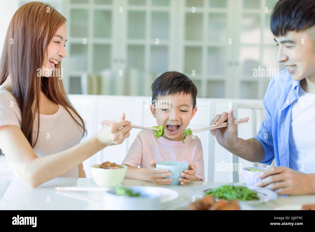 Happy Asian  family having dinner at home Stock Photo