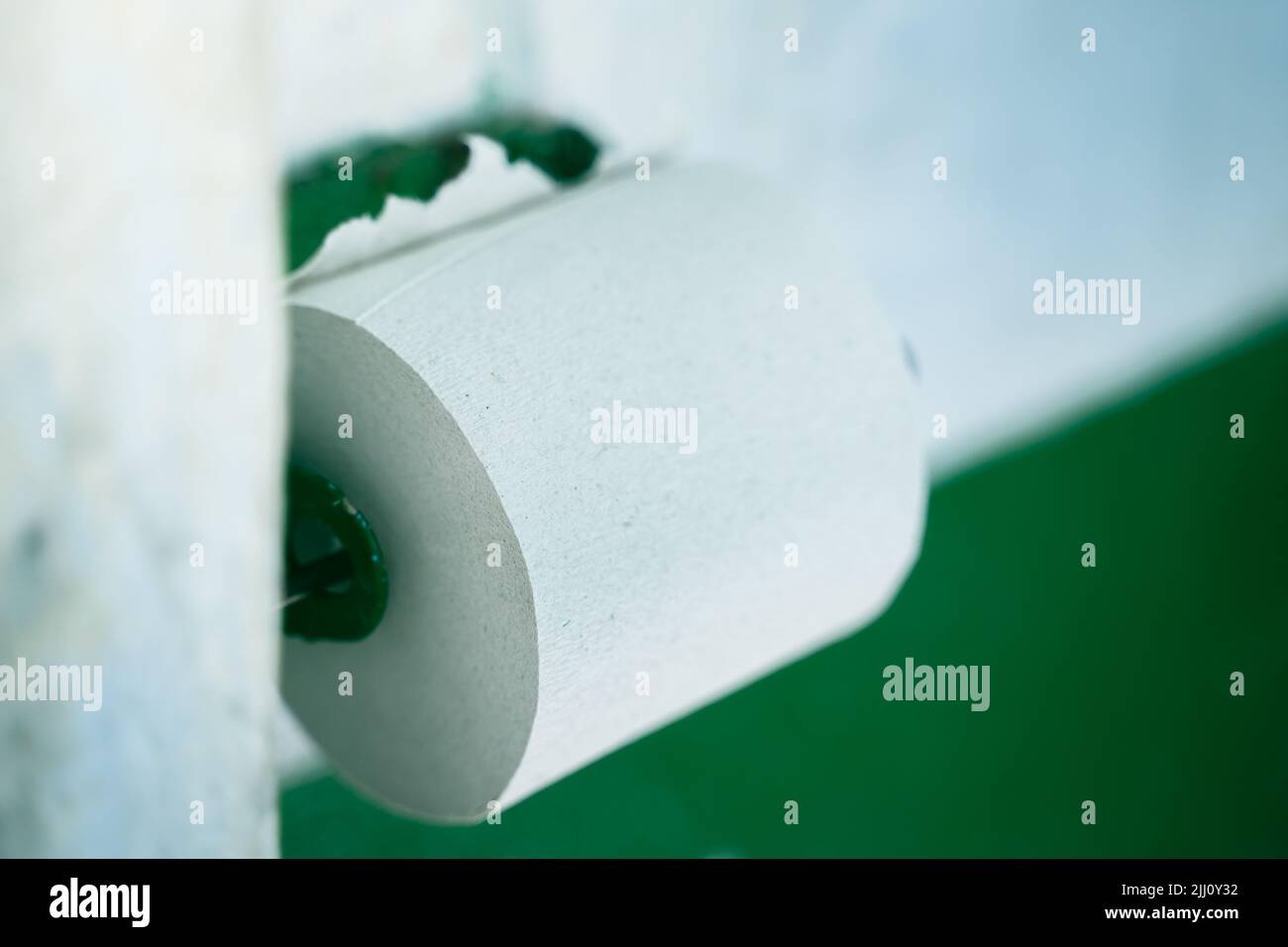 Toilet paper holder with cheap low quality single ply toilet paper