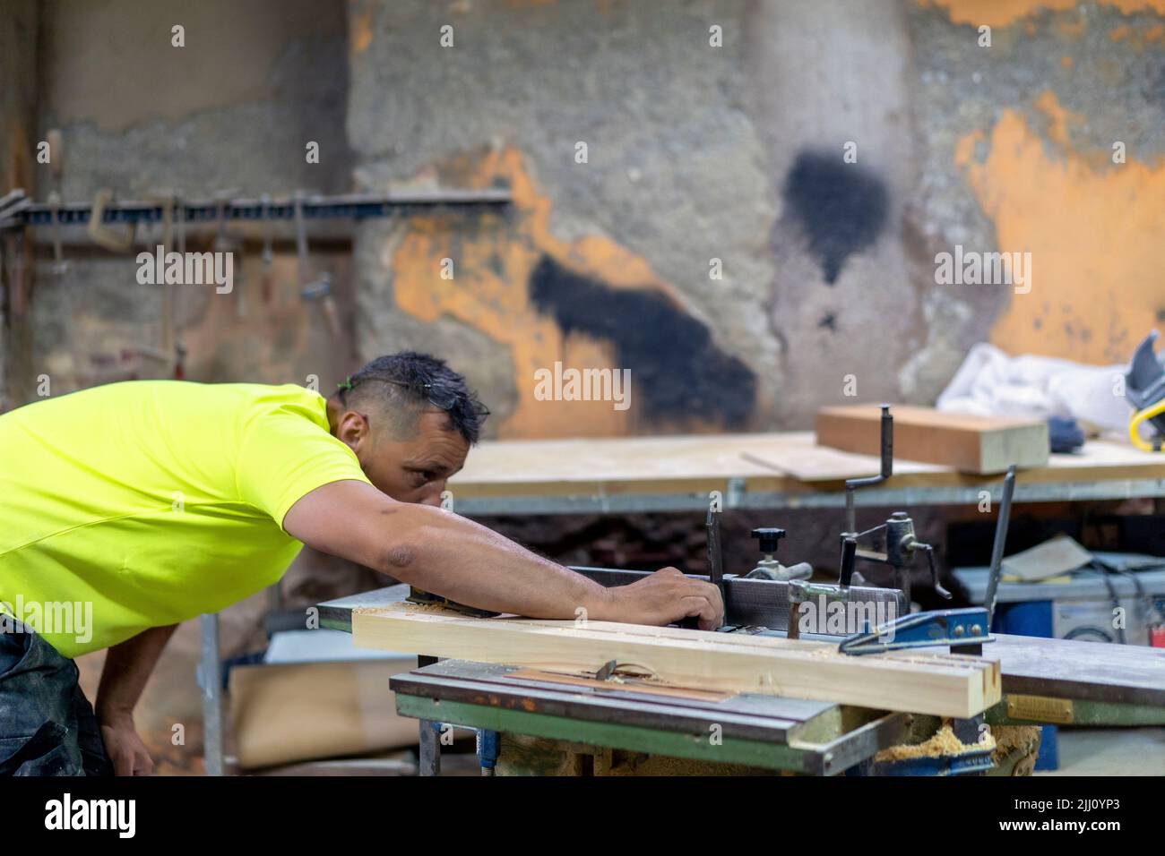 master carpenter adjusting his grinding machine in his workshop Stock Photo