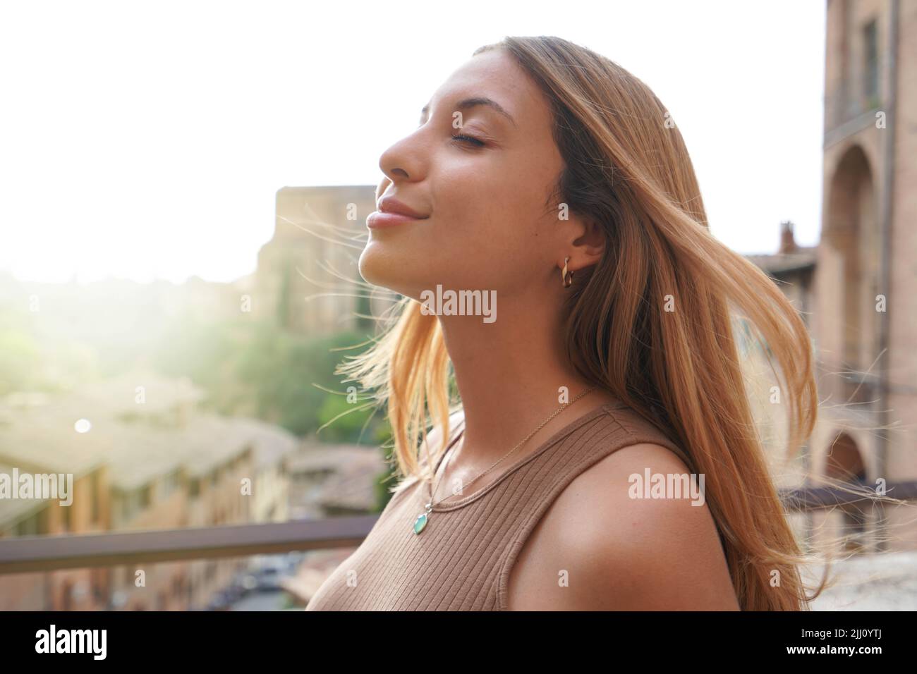 Profile of woman breathe relaxed with closed eyes on sunset. Beauty sunshine girl side portrait. Positive emotion life success mind peace concept. Stock Photo