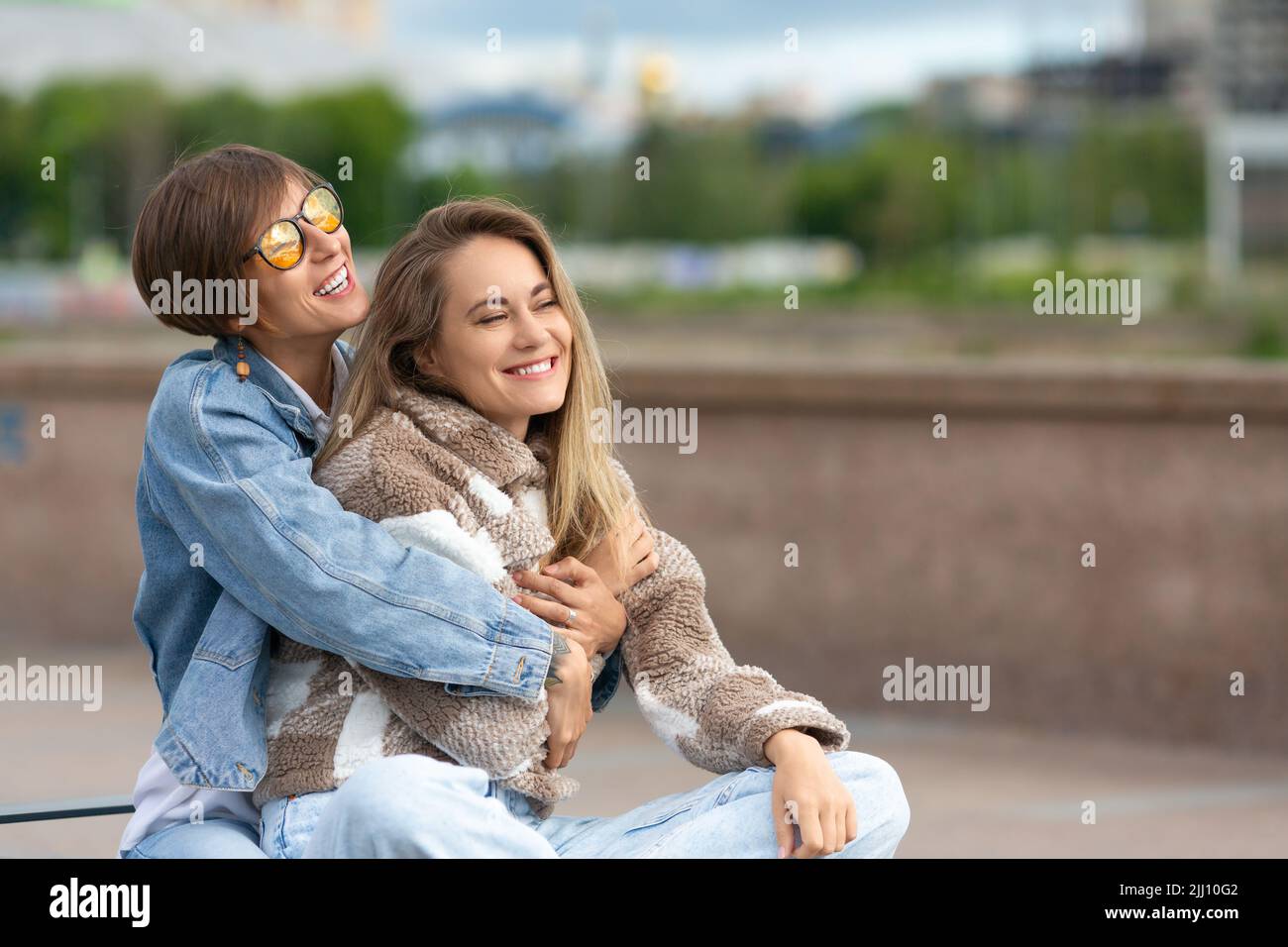Love and relationships concept. Lesbian couple during outdoor walking. Beautiful romantic moment between two female lovers. Stock Photo