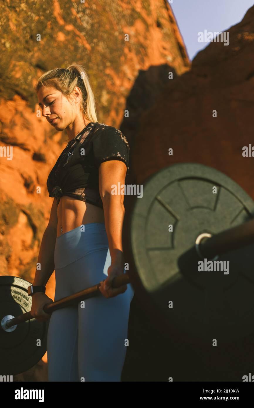 Young woman doing crossfit exercise outdoors in the desert surro Stock Photo
